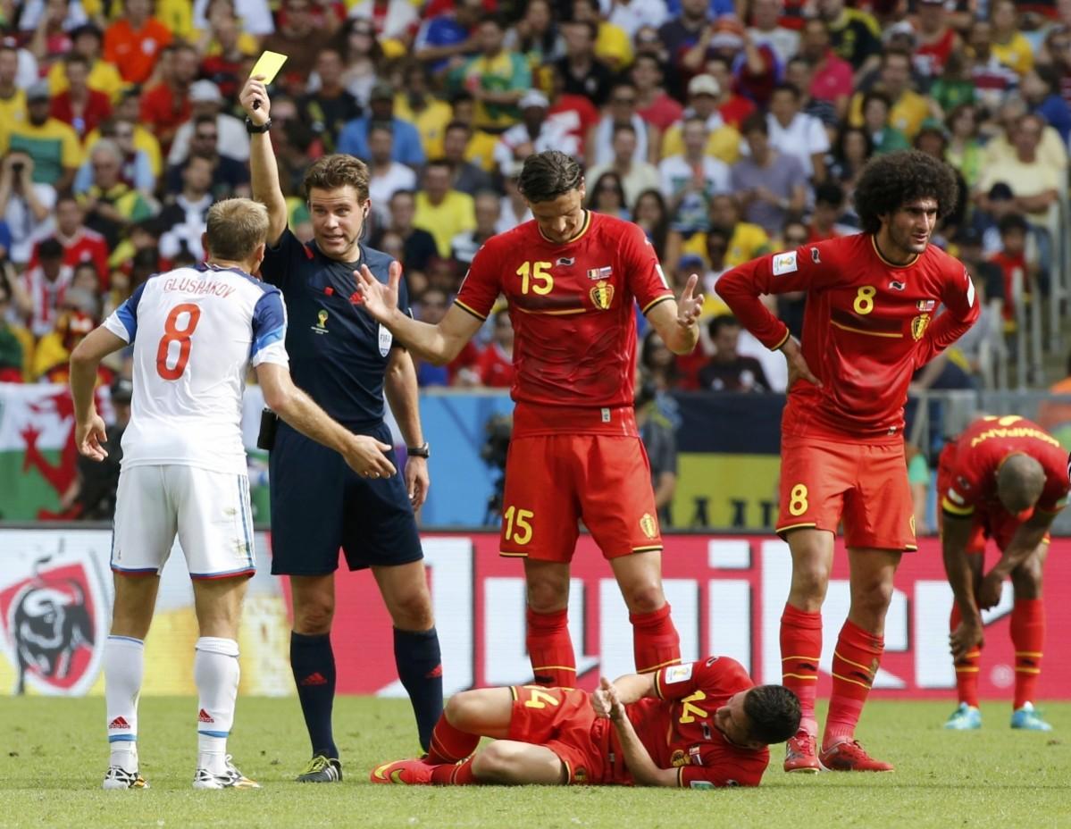 Russia's Glushakov is given a yellow card after fouling Belgium's Mertens during their 2014 World Cup Group H match at the Maracana stadium in Rio de Janeiro Belgium vs Russia