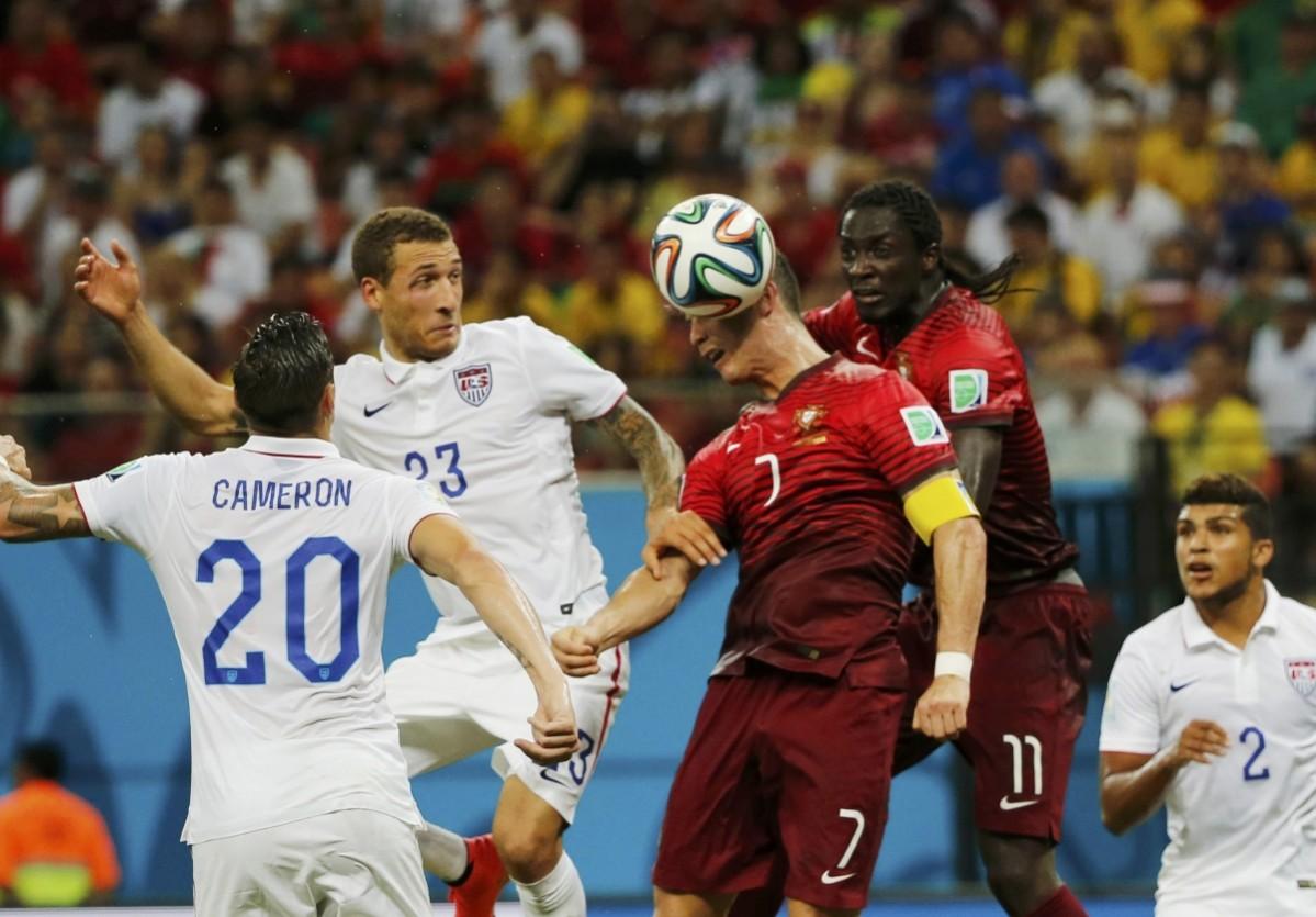 Portugal's Ronaldo jumps to head the ball near teammate Eder, Cameron and Johnson of the U.S. during their 2014 World Cup G match at the Amazonia arena in Manaus USA vs Portugal