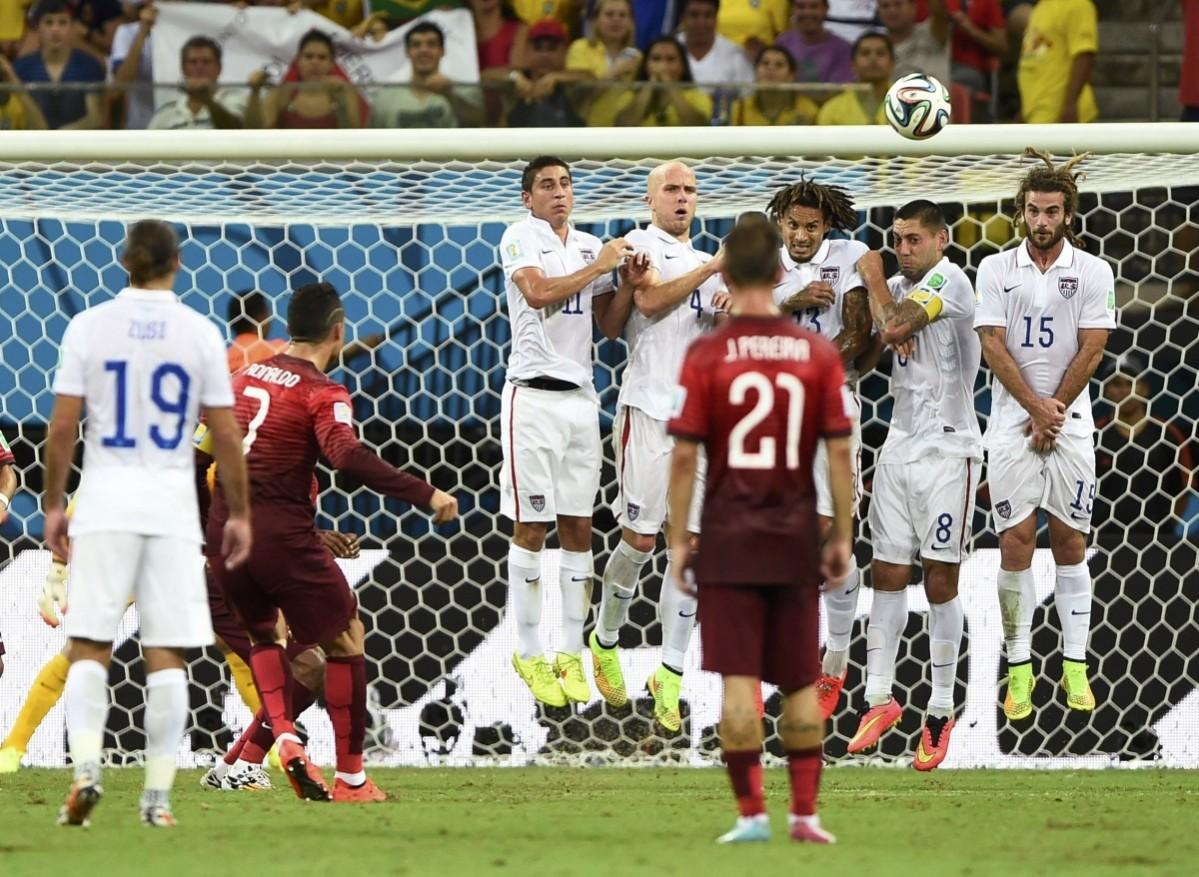 Portugal's Ronaldo takes a free kick as U.S national soccer players jump to defend during their 2014 World Cup G match at the Amazonia arena in Manaus USA vs Portugal