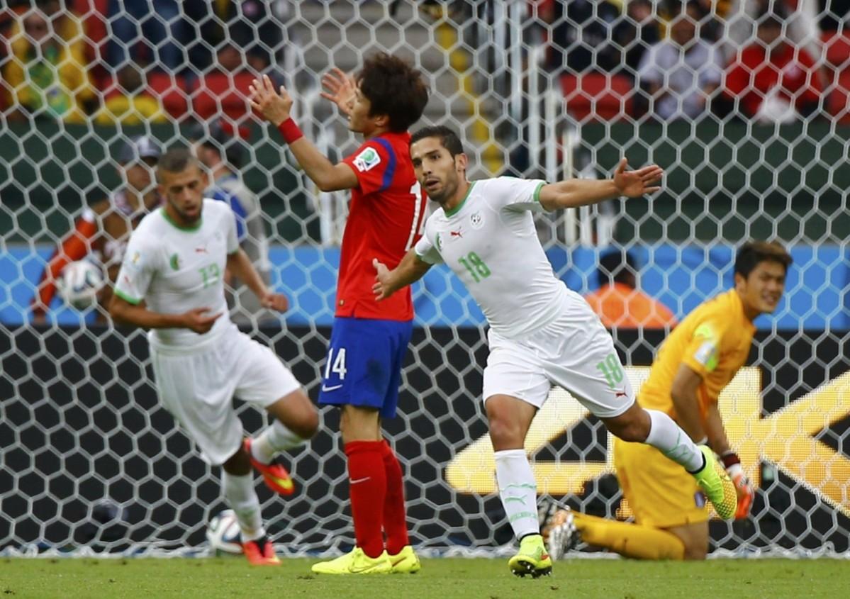 Algeria's Abdelmoumene Djabou celebrates with Islam Slimani after scoring a goal during World Cup Group H soccer match at Beira Rio stadium South Korea v Algeria