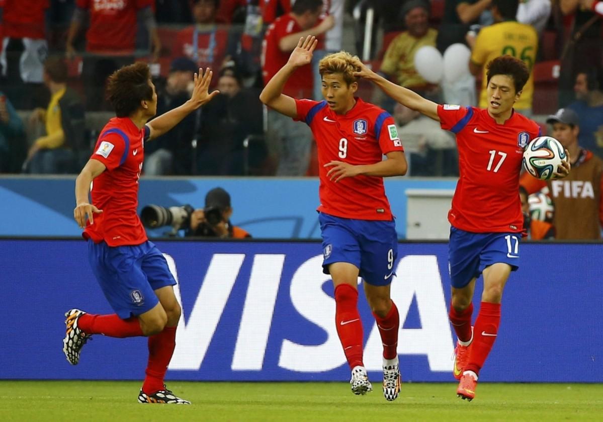 South Korea's Son Heung-min celebrates with Koo Ja-cheol and Lee Chung-yong after scoring a goal during the 2014 World Cup Group H soccer match between South Korea and Algeria at the Beira Rio stadium South Korea v Algeria