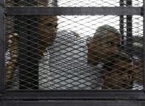 Peter Greste, Mohamed Fahmy and Baher Mohamed listen to the ruling at a court in Cairo
