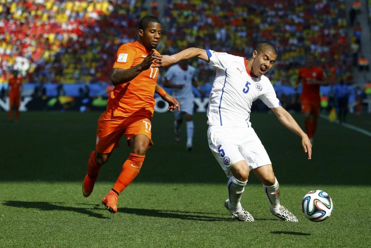 Chile's Silva fights for the ball with Lens of the Netherlands during their 2014 World Cup Group B match at the Corinthians arena in Sao Paulo Netherlands v Chile