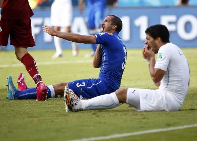 Italy defender Giorgio Chiellini reacts after allegedly being bitten by Uruguay striker Luis Suarez, 24 June Giorgio Chiellini Luis Suarez Uruguay Italy