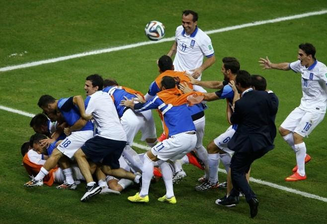 Greece players celebrate the winning goal against Ivory Coast, 24 June Greece