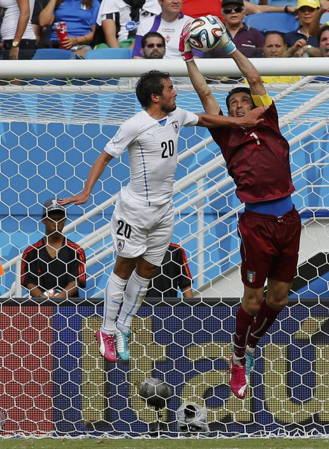 Italy's Buffon makes a save next to Uruguay's Gonzalez during their 2014 World Cup Group D match at the Dunas arena in Natal Italy vs Uruguay