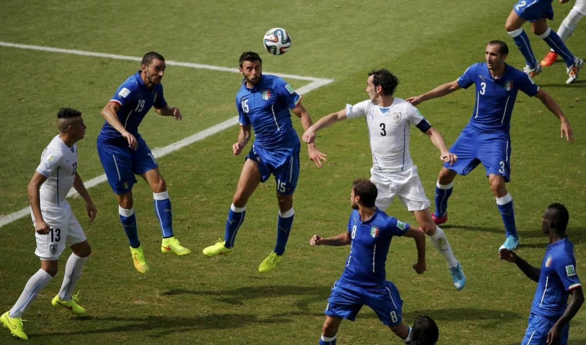 Italy's Barzagli heads the ball against Uruguay's Diego Godin (4th R) during their 2014 World Cup Group D match at the Dunas arena in Natal Italy vs Uruguay