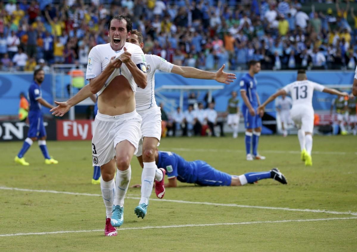 Uruguay's Diego Godin celebrates with team mate Christian Stuani after scoring a goal during their 2014 World Cup Group D match against Italy at the Dunas arena in Natal Italy vs Uruguay