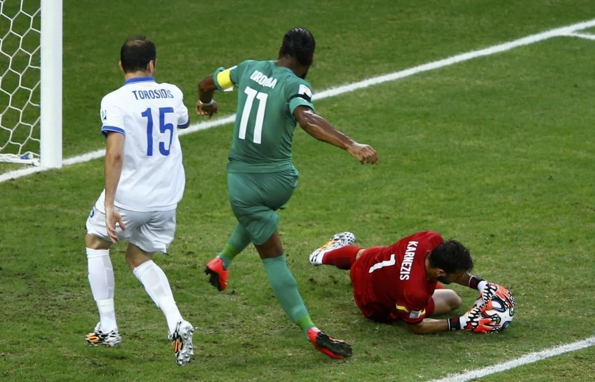 Greece's Karnezis makes a save near Ivory Coast's Drogba during their 2014 World Cup Group C soccer match in Fortaleza Greece vs Ivory Coast