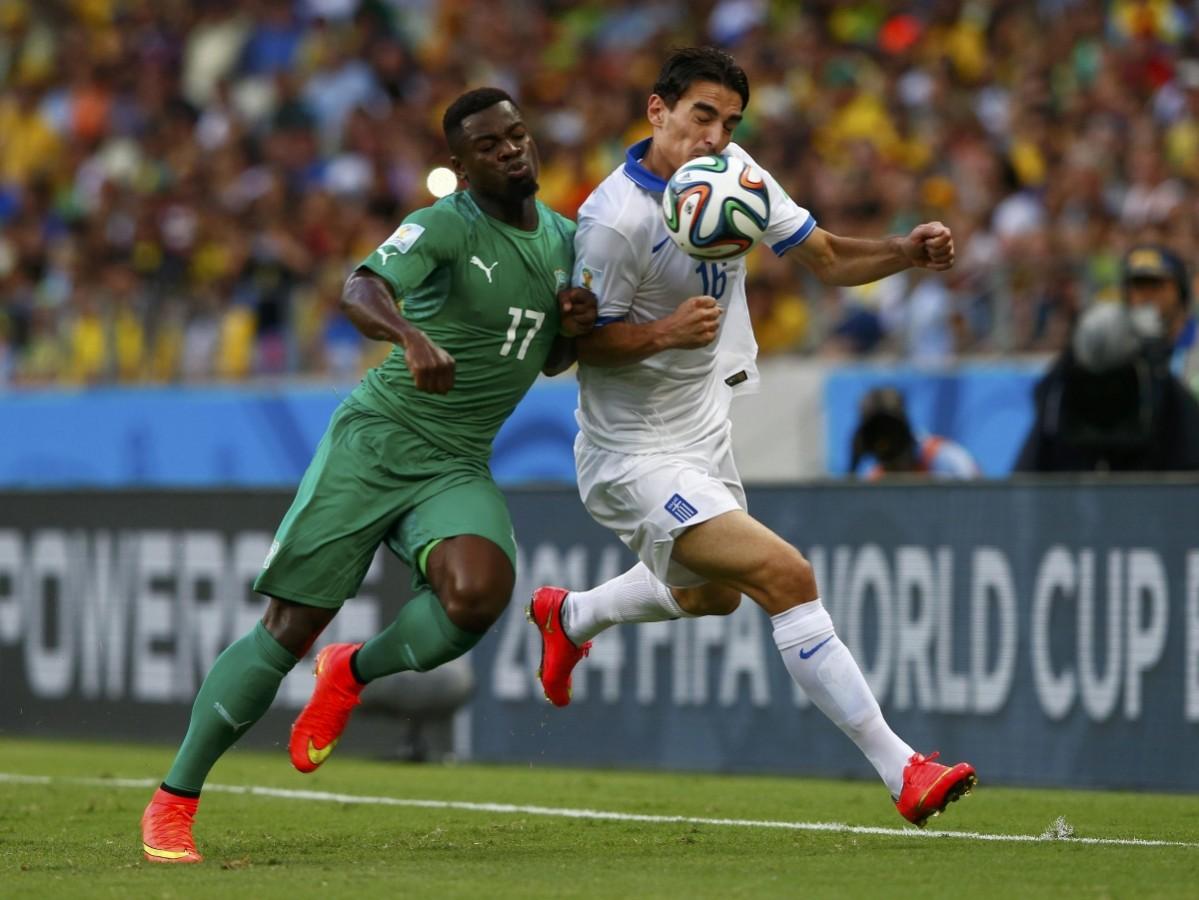 Ivory Coast's Aurier fights for the ball with Greece's Christodoulopoulos their 2014 World Cup Group C soccer match at the Castelao arena in Fortaleza Greece vs Ivory Coast