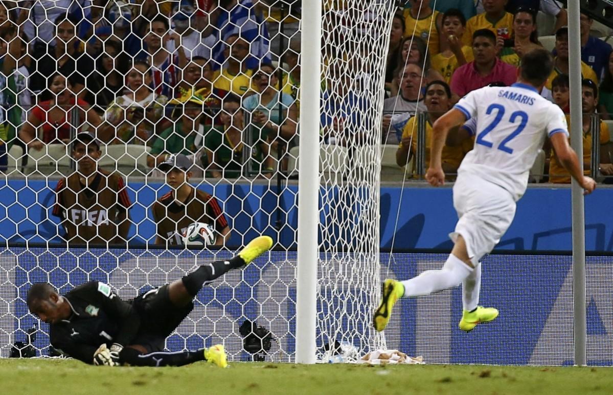 Greece's Samaris shoots to score a goal past Ivory Coast's Barry during their 2014 World Cup Group C soccer match at the Castelao arena in Fortaleza Greece vs Ivory Coast