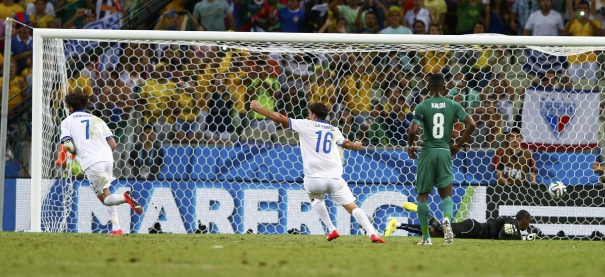 Greece's Christodoulopoulos celebrates after teammate Samaras scored on a penalty kick during their 2014 World Cup Group C soccer match against Ivory Coast at the Castelao arena in Fortaleza Greece vs Ivory Coast