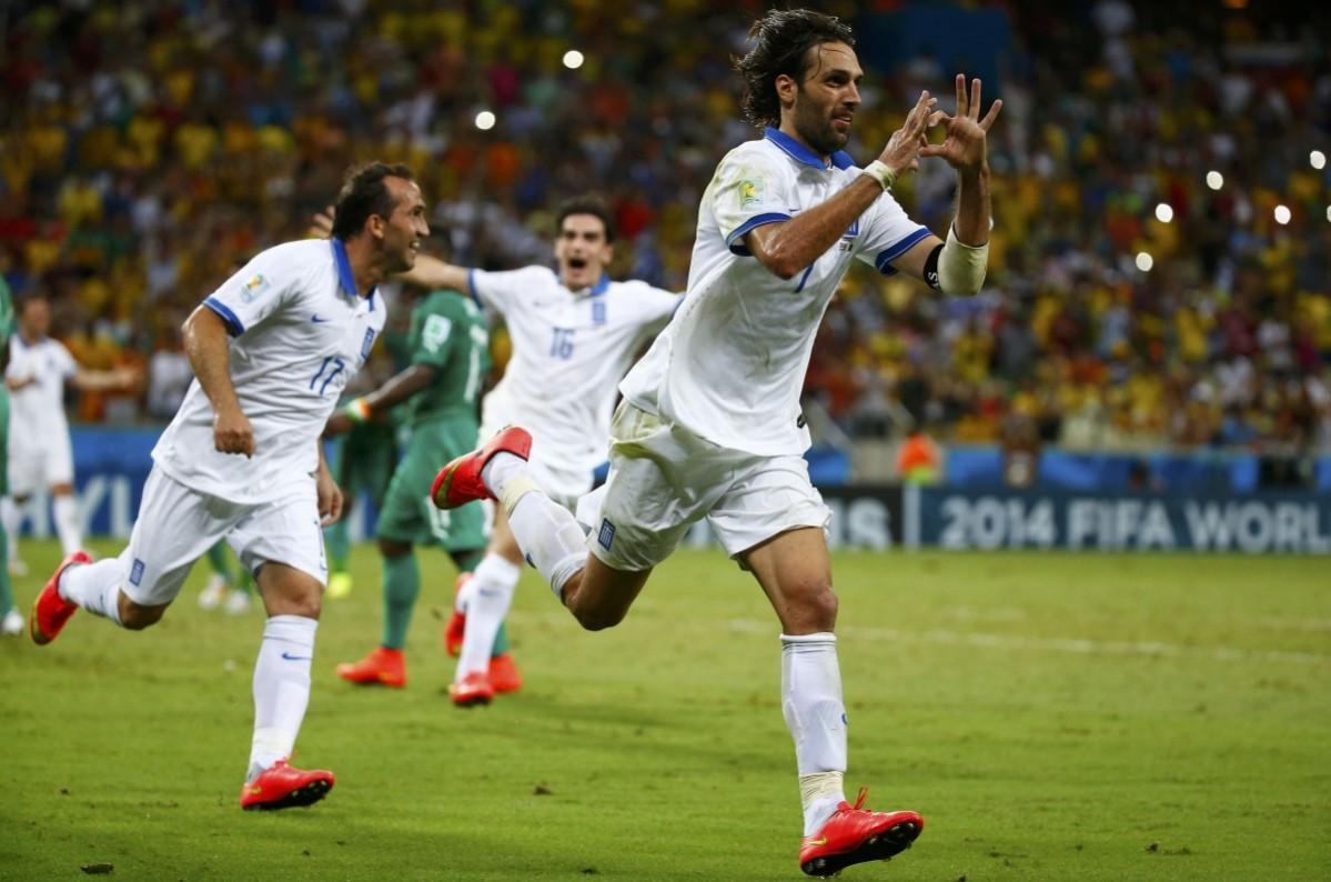 Greece's Giorgios Samaras forms a heart shape with his hands as he celebrates scoring a goal against Ivory Coast during their 2014 World Cup Group C soccer match at the Castelao arena in Fortaleza Greece vs Ivory Coast