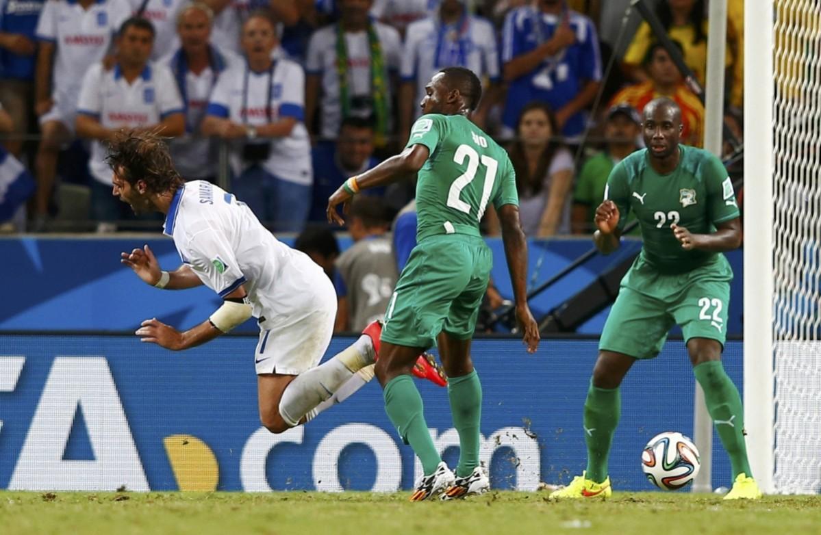 Ivory Coast's Sio commits a foul on Greece's Samaras during their 2014 World Cup Group C soccer match at the Castelao arena in Fortaleza Greece vs Ivory Coast