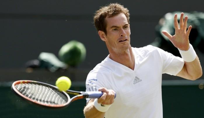 Andy Murray of Britain hits a return to Blaz Rola of Slovenia. Andy Murray