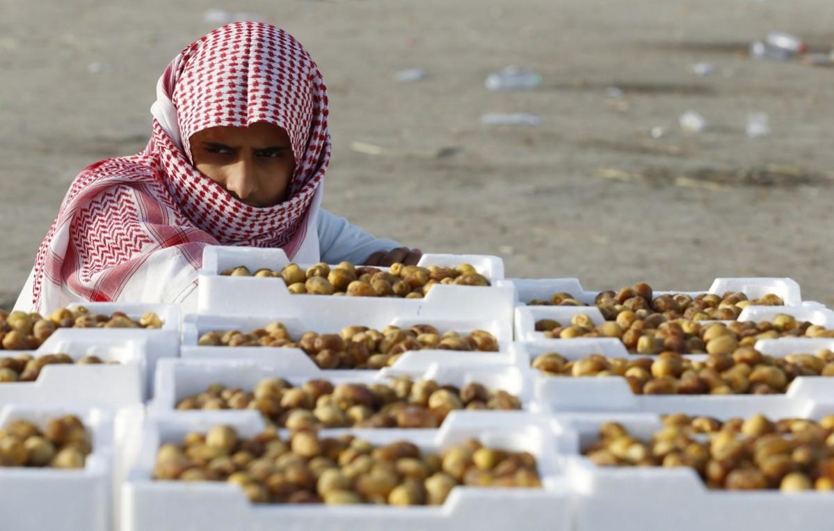 Vendor looks on as he sells dates at a market ahead of the holy fasting month of Ramadan at Utaiqah neighbourhood, south of Riyadh Ramadan 2014