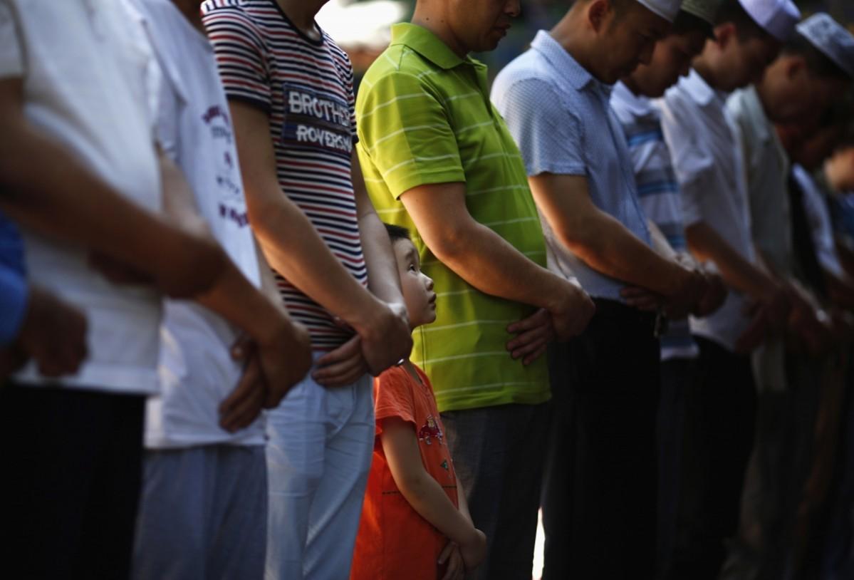 A boy attends a Friday prayer outside a worship hall of the Niujie Mosque in Beijing, ahead of the holy fasting month of Ramadan Ramadan 2014