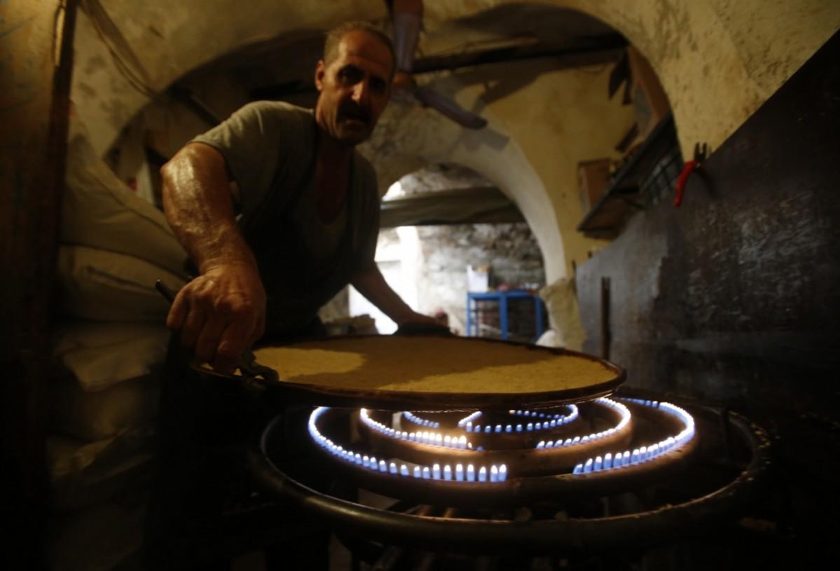 A man prepares traditional sweets ahead of the holy fasting month of Ramadan at the port city of Sidon Ramadan 2014