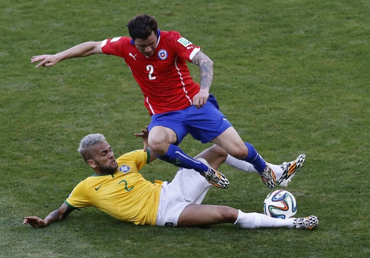 Brazil's Alves and Chile's Mena fight for the ball during their 2014 World Cup round of 16 game at the Mineirao stadium in Belo Horizonte Brazil v Chile