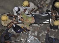 Rescue workers carry an injured man at the site of a collapsed 11-storey building that was under construction on the outskirts of the southern Indian city of Chennai