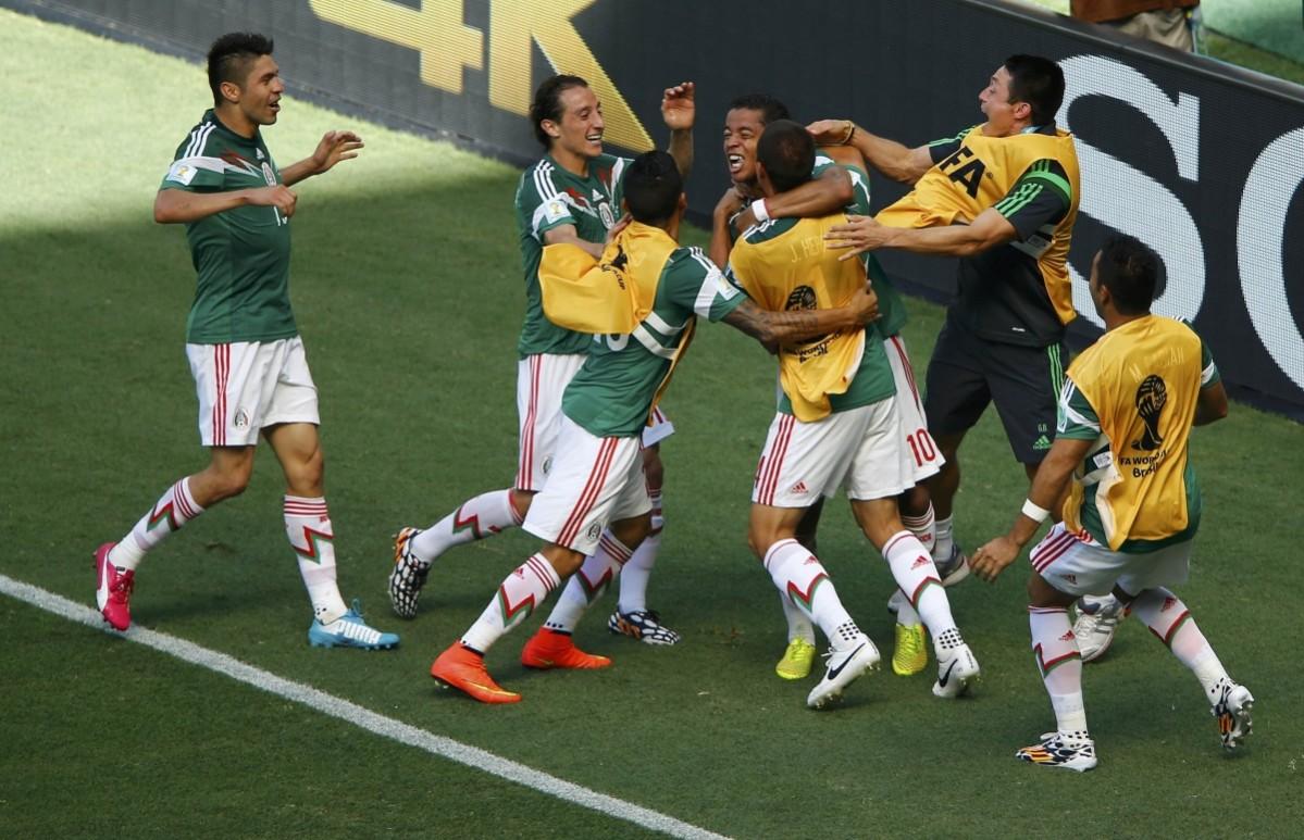 Mexico's Giovani Dos Santos celebrates after scoring a goal during the 2014 World Cup round of 16 game between Mexico and the Netherlands at the Castelao arena Netherlands vs Mexico