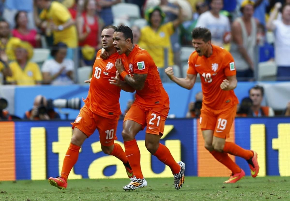 Sneijder of the Netherlands celebrates with his teammates Depay and Huntelaar after scoring a goal against Mexico during their 2014 World Cup round of 16 game at the Castelao arena in Fortaleza Netherlands v Chile