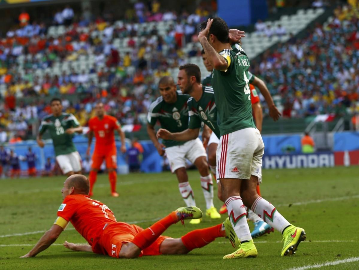 Arjen Robben of the Netherlands is fouled in the penalty area during their 2014 World Cup round of 16 game against Mexico at the Castelao arena in Fortaleza Netherlands vs Mexico
