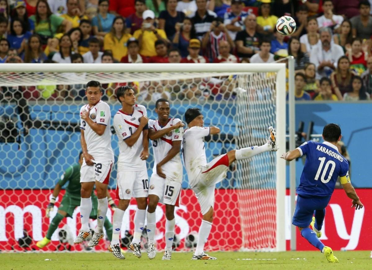 Greece's Giorgos Karagounis takes a free kick during their 2014 World Cup round of 16 game against Costa Rica at the Pernambuco arena in Recife Costa Rica vs Greece
