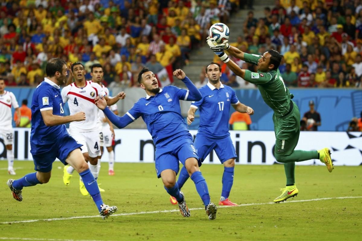 Costa Rica's goalkeeper Navas makes a save in front of Greece's national soccer players during their 2014 World Cup round of 16 game at the Pernambuco arena in Recife Costa Rica vs Greece