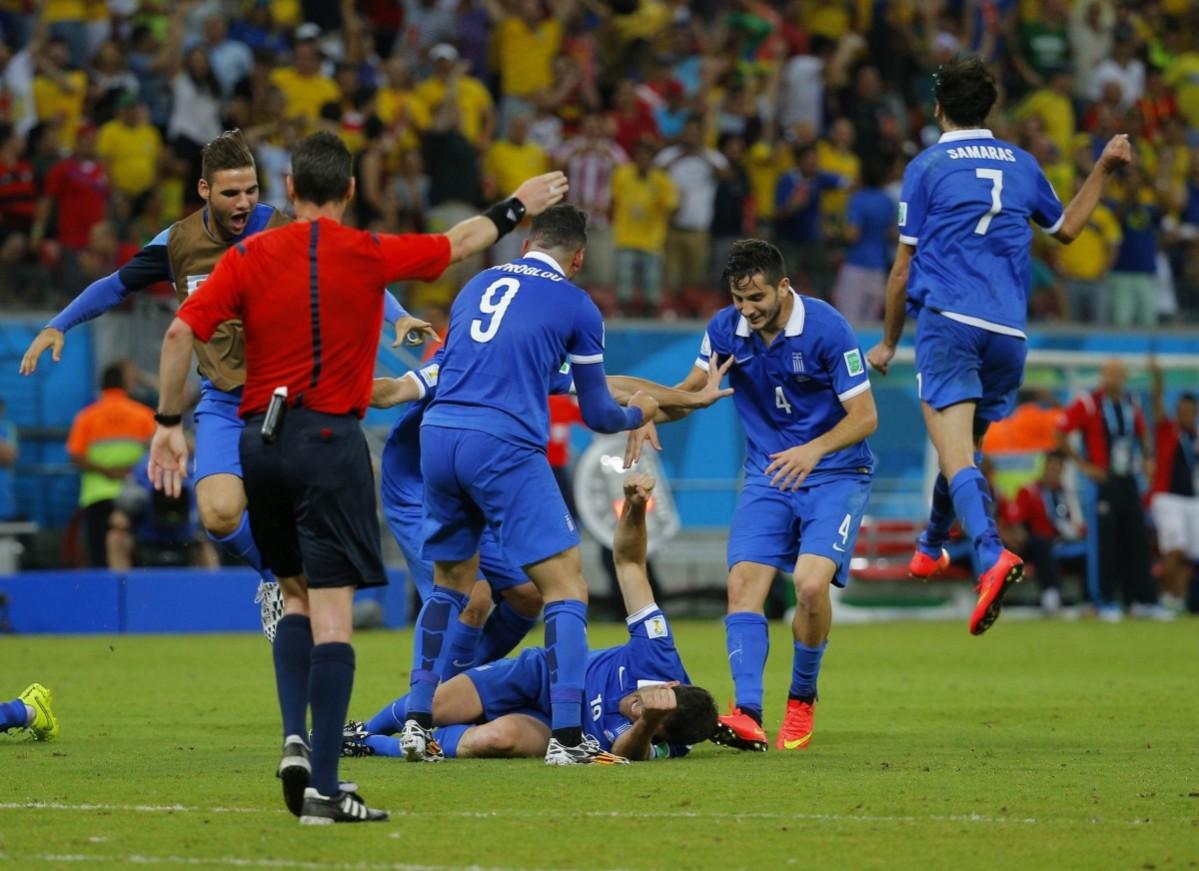Greece's Papastathopoulos celebrates with his teammates after scoring a goal against Costa Rica during their 2014 World Cup round of 16 game at the Pernambuco arena in Recife Costa Rica vs Greece