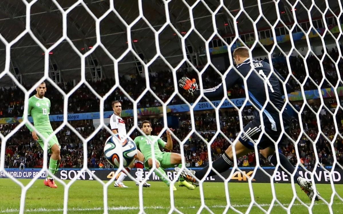 Algeria's Abdelmoumene Djabou scores past Germany's goalkeeper Manuel Neuer during their 2014 World Cup round of 16 game at the Beira Rio stadium Germany vs Algeria