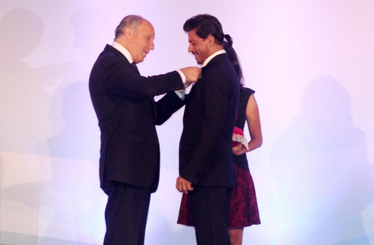 French Foreign Minister Laurent Fabius presents Shah Rukh Khan
