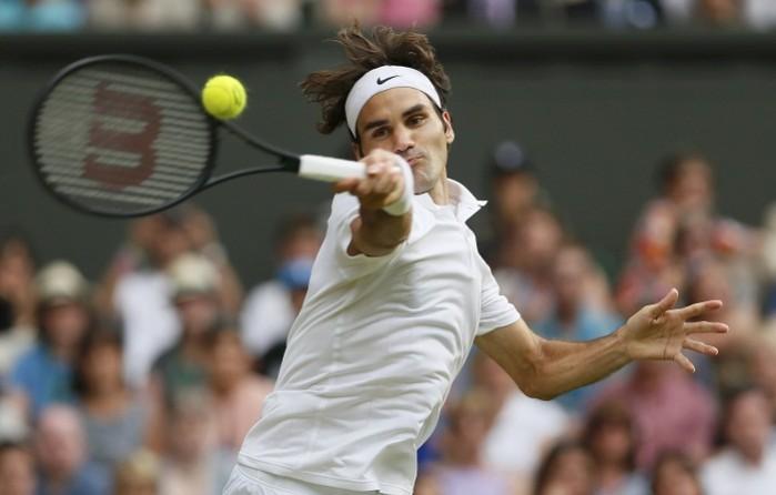 Roger Federer hits a return during his match against Stanislas Wawrinka. Roger Federer