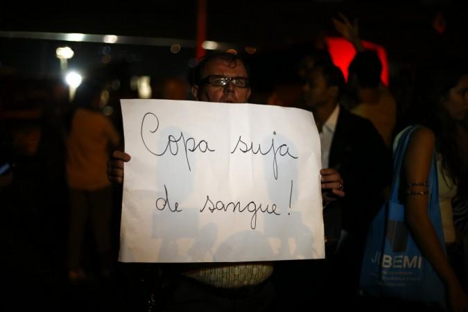 A man holds a banner that reads A man holds a banner that reads