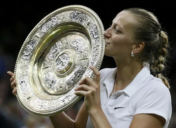 Petra Kvitova holds the winners trophy, the Venus Rosewater Dish, after defeating Eugenie Bouchard. Petra Kvitova