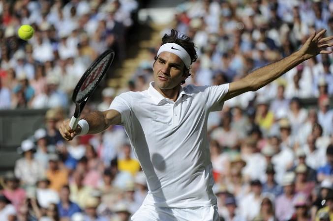 Roger Federer of Switzerland hits a return against Milos Raonic of Canada. Roger Federer