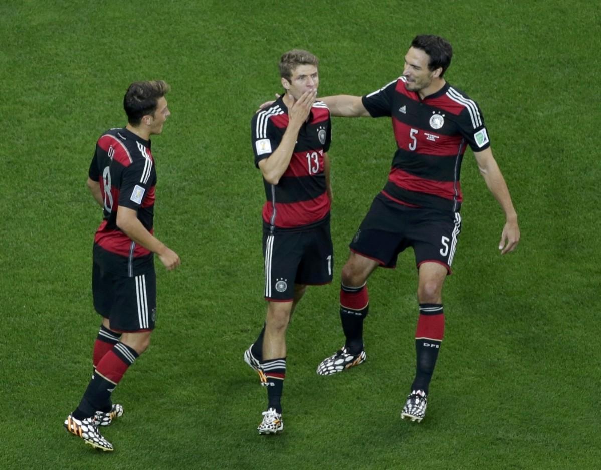 Germany's Thomas Mueller celebrates his goal with team mates Mesut Ozil and Mats Hummels during their 2014 World Cup semi-finals against Brazil at the Mineirao stadium in Belo Horizonte Brazil vs Germany