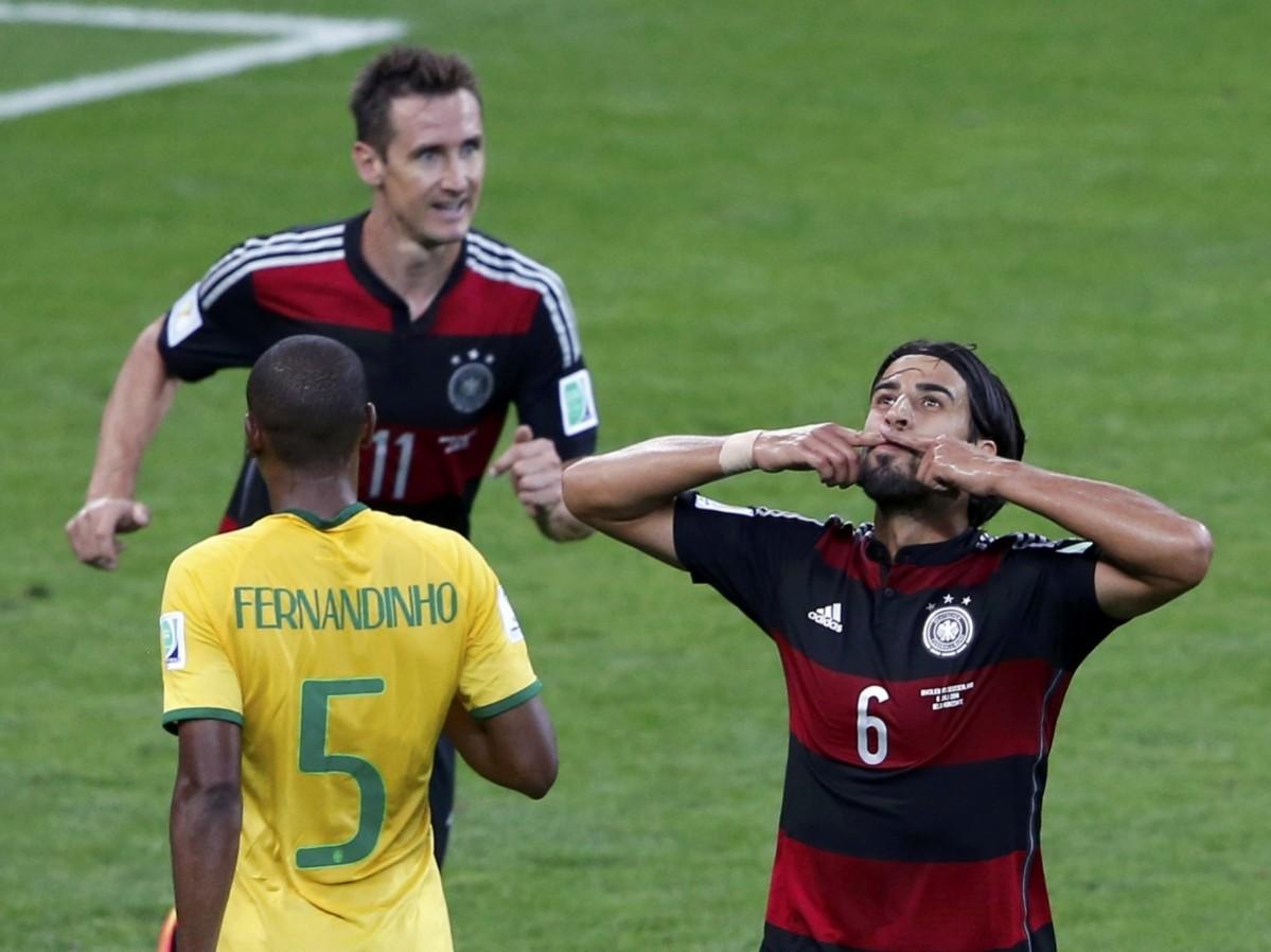 Germany's Khedira celebrates past his teammate Klose and Brazil's Fernandinho after scoring his team's fifth goal during their 2014 World Cup semi-finals at the Mineirao stadium in Belo Horizonte Brazil vs Germany