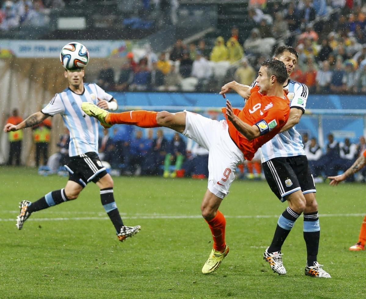 Van Persie of the Netherlands fights for the ball with Argentina's Demichelis during their 2014 World Cup semi-finals in Sao Paulo Netherlands vs Argentina