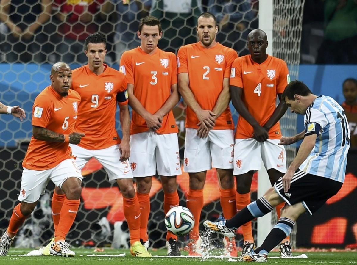Argentina's Messi takes a free kick near Netherlands' players during their 2014 World Cup semi-finals at the Corinthians arena in Sao Paulo Netherlands vs Argentina