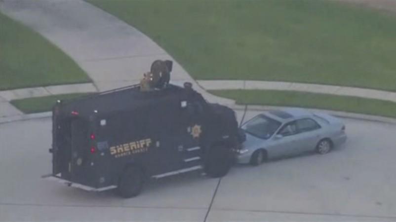 Still image taken from KPRC-TV aerial video footage of police and suspect's vehicles in a standoff at a residential neighborhood following a shooting incident in Spring, Texas. Still image taken from KPRC-TV aerial video footage of police and suspect's vehicles in a standoff at a residential neighborhood following a shooting incident in Spring, Texas