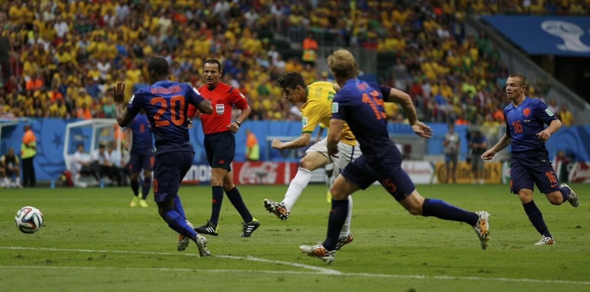Brazil's Oscar attempts a shot against the Netherlands during their 2014 World Cup third-place playoff at the Brasilia national stadium in Brasilia Brazil vs Netherlands