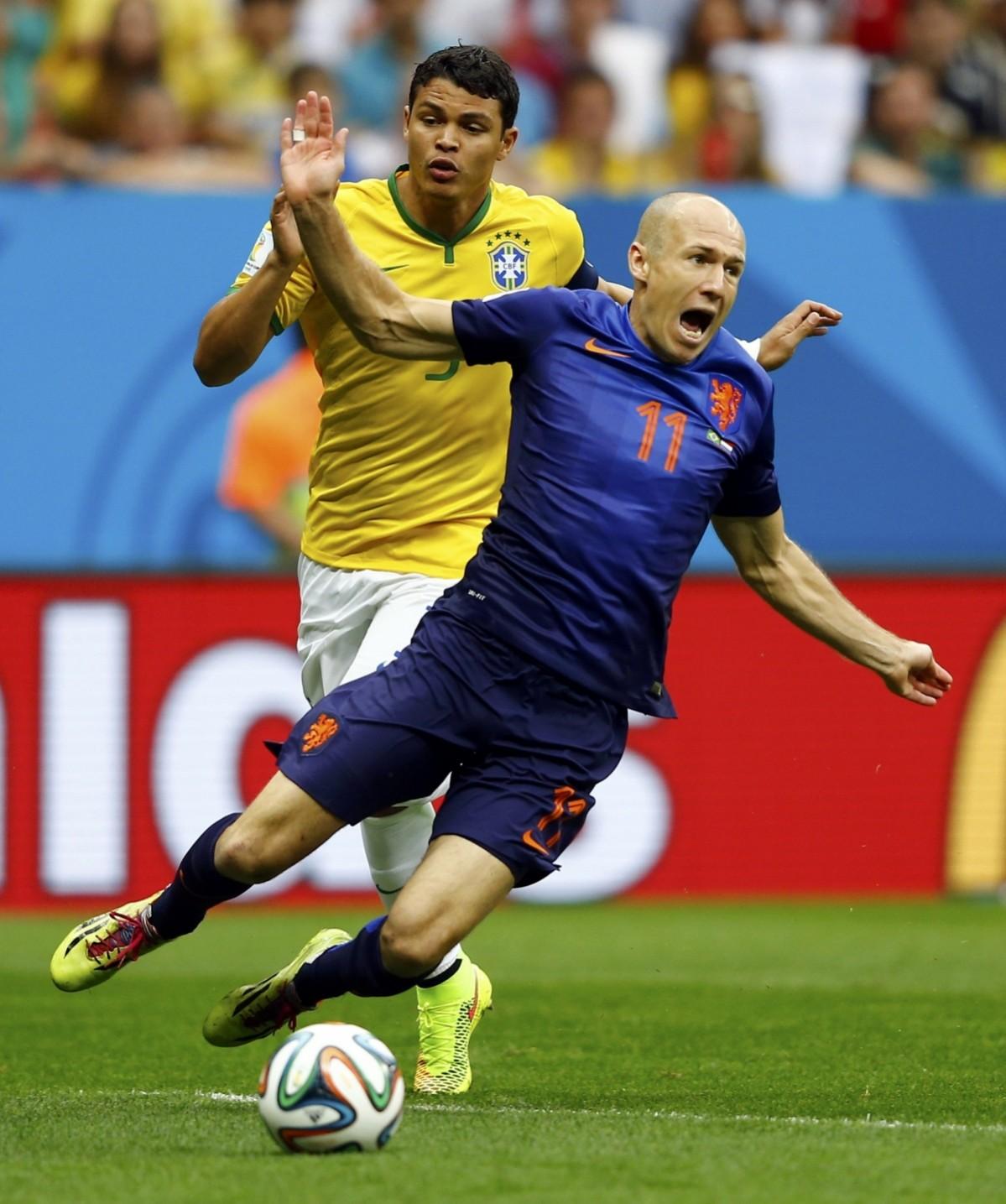 Brazil's Silva fouls Robben of the Netherlands to concede a penalty during their 2014 World Cup third-place playoff at the Brasilia national stadium in Brasilia Brazil vs Netherlands