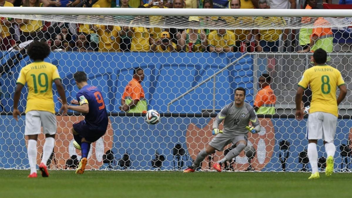 Robin van Persie of the Netherlands shoots to score his penalty past Brazil's Cesar during their 2014 World Cup third-place playoff at the Brasilia national stadium in Brasilia Brazil vs Netherlands