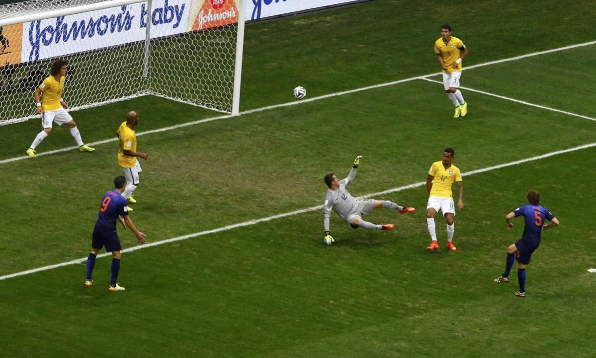 Blind of the Netherlands scores past Brazil's goalkeeper Cesar during their 2014 World Cup third-place playoff in Brasilia Brazil vs Netherlands