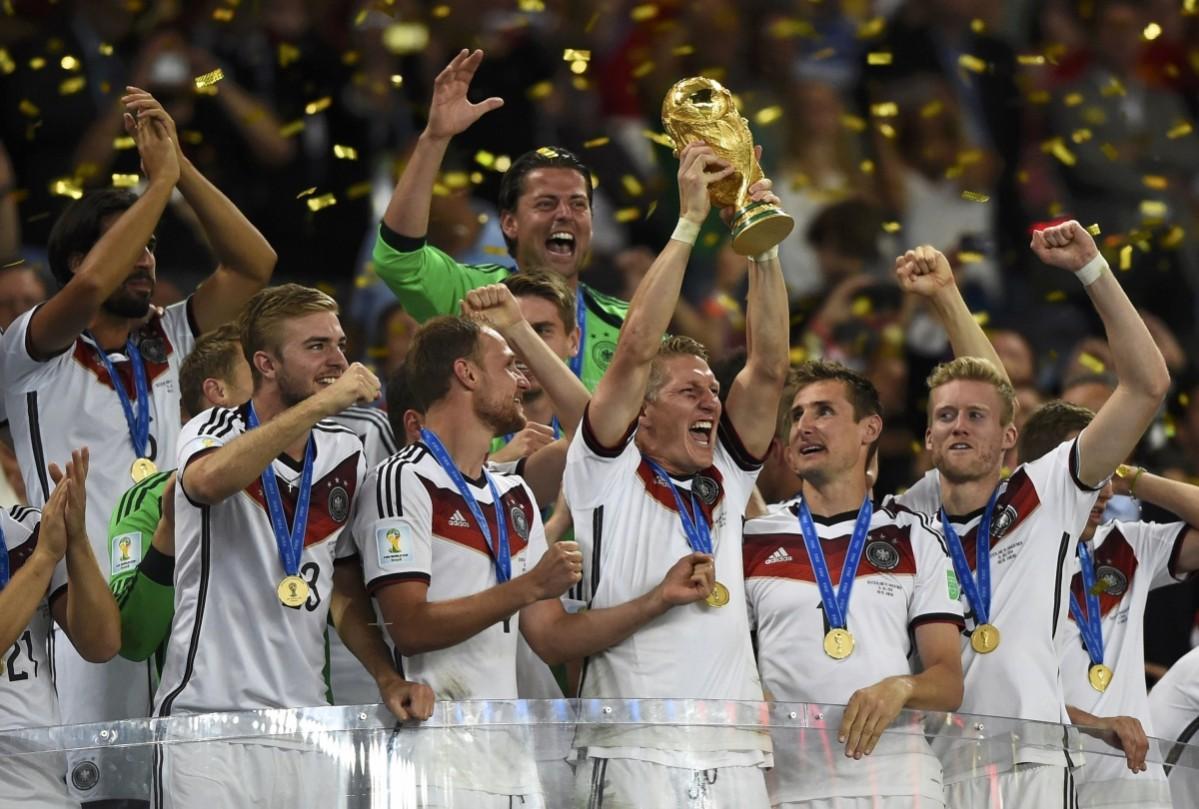 Bastian Schweinsteiger of Germany lifts the World Cup trophy with