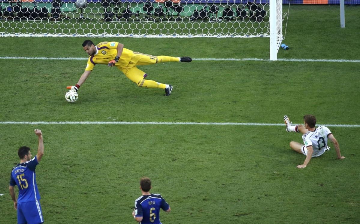 Argentina's goalkeeper Sergio Romero stops a goal attempt by Germany's Thomas Mueller during 2014 World Cup final at the Maracana stadium in Rio de Janeiro. Germany vs Argentina