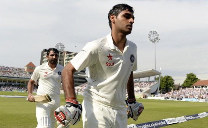 India's Mohammed Shami and team-mate Bhuvneshwar Kumar leave the field in the first Test match. Mohammad Shami and Bhuvneshwar Kumar