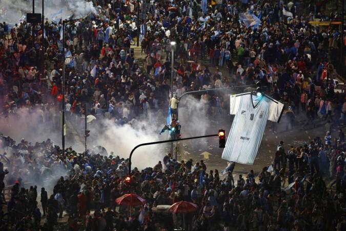 Argentina's fans run away from tear gas as they clash with riot police in Buenos Aires after Argentina lost to Germany in their 2014 World Cup final match in Brazil Argentina's fans run away from tear gas as they clash with riot police in Buenos Aires after Argentina lost to Germany in their 2014 World Cup final match in Brazil