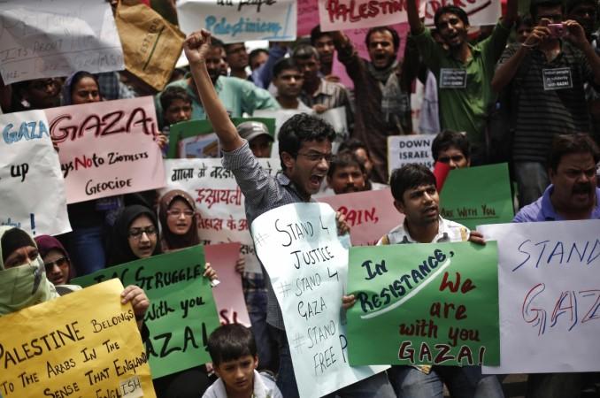 Demonstrators hold placards and shout slogans during a protest rally against the Israel's attacks on Gaza, outside the Israeli embassy in New Delhi Demonstrators hold placards and shout slogans during a protest rally against the Israel's attacks on Gaza, outside the Israeli embassy in New Delhi